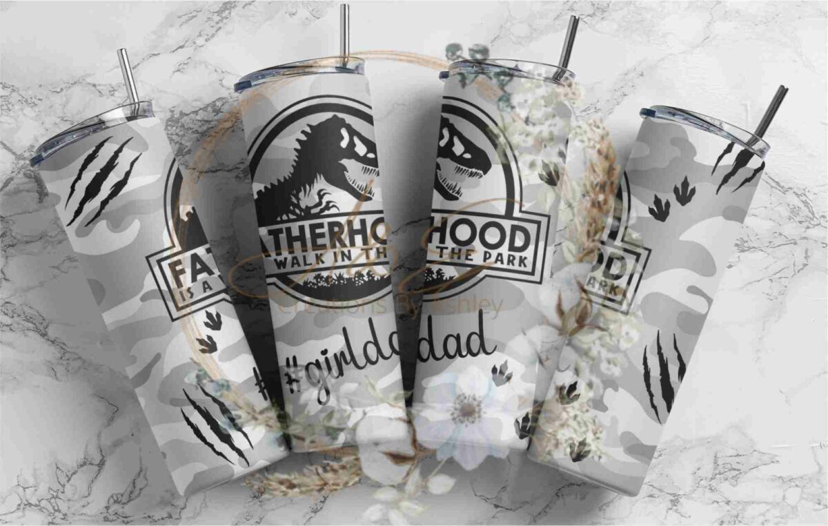 Four stainless steel tumblers with camouflage patterns and dinosaur graphics. Each tumbler has text: "Fatherhood is a walk in the park." The tumblers are arranged in a row, and one features the hashtag "#girldad.