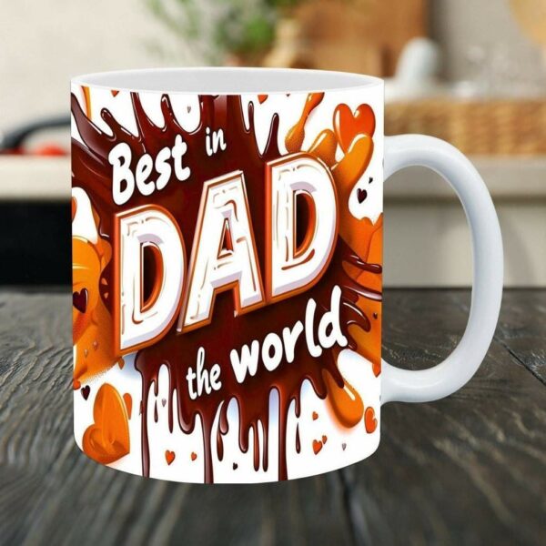 White ceramic mug with the words "Best Dad in the world" printed in orange and brown lettering with heart decorations. The mug is placed on a dark wooden surface.