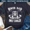 A black T-shirt with the text "Biker Dad Like a Normal Dad Only Cooler" featuring a motorcycle graphic. It's displayed with white sneakers and blue jeans on a wooden surface.