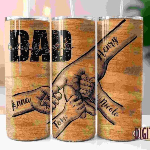 Three wooden tumblers with illustrations of hands. The first tumbler has the name Anna, the second has the names Tom and Dad with "blessed" in the background, and the third has the names Amy and Nicole.