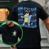 A person wearing a black T-shirt with a graphic of a cartoon dog and the text "Cool Dads Club" repeatedly printed on the back. An inset shows the front of the shirt with the same image in a smaller size.