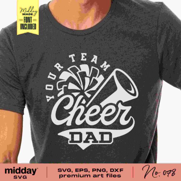 Close-up of a person wearing a dark gray t-shirt with the phrase "Your Team Cheer Dad" printed on it in white letters. The design includes a pom-pom and a megaphone graphic above the text. The image also has branding details and file format availability listed at the bottom.