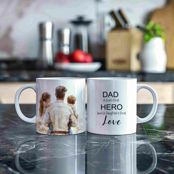 Alt Text: Two ceramic mugs on a marble countertop. The left mug features a family illustration on the back. The right mug has the text, "DAD A Son's First HERO And A Daughter's First Love" on the front.