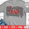 Gray T-shirt with the word "Dad" in large red letters surrounded by words like hero, strong, supportive, brave, loyal, teacher, and provider in black and red. The words form a rectangular shape. Near the T-shirt are a pair of black and white sneakers and folded jeans.