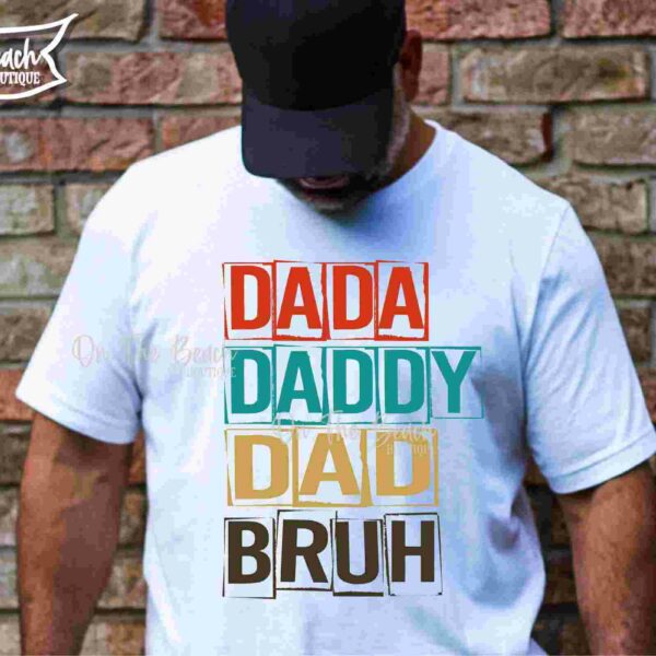 Alt Text: Man wearing a white T-shirt with the words "DADA," "DADDY," "DAD," and "BRUH" stacked in different colors, standing against a brick wall. Text on the right reads "SVG PNG EPS DXF.