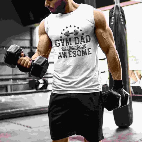 A man in a gym setting, wearing a sleeveless shirt that reads "Gym Dad: Like a Normal Dad Only Much More Awesome," and holding dumbbells in each hand.