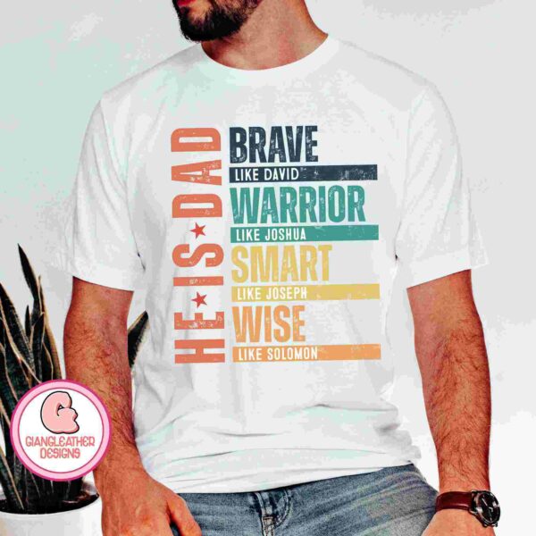 A person wearing a white T-shirt with colorful text that reads, "He is Dad: Brave like David, Warrior like Joshua, Smart like Joseph, Wise like Solomon." The logo "Giangleather Designs" is visible in the bottom left corner.
