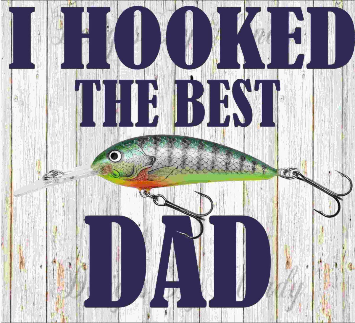 Alt Text: A fishing lure with the text "I Hooked the Best Dad" written in bold letters against a wooden background.