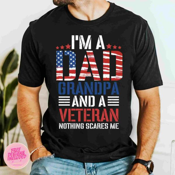 A person wearing a black T-shirt that reads, "I'm a Dad, Grandpa, and a Veteran, nothing scares me," with patriotic colors and designs.