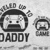 Black and white graphic design featuring gaming controllers. Text reads "Leveled Up to Daddy" and "Player 2 Has Entered the Game." Includes file format labels: SVG, PNG, DXF, EPS, 300 dpi.