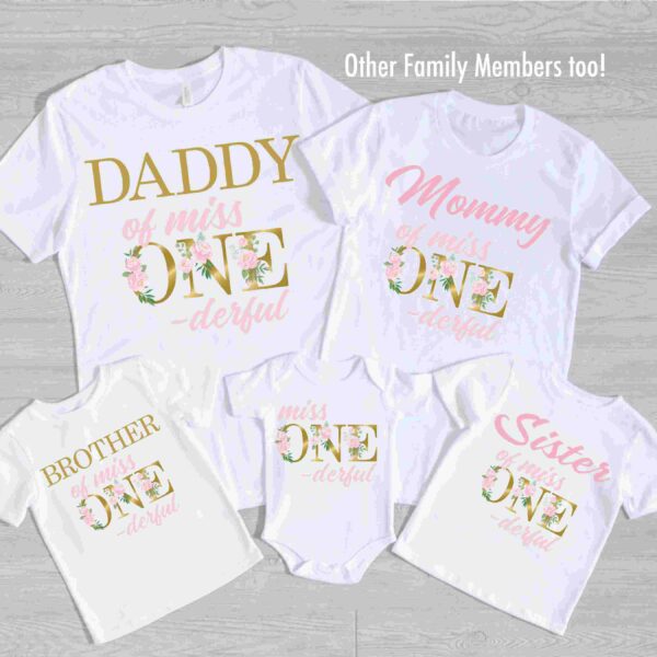 A set of five white shirts laid out, each with floral-themed text reading "Daddy of miss ONE-derful," "Mommy of miss ONE-derful," "Brother of miss ONE-derful," "Sister of miss ONE-derful," and "miss ONE-derful.