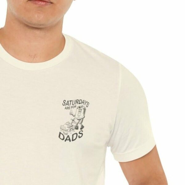 Person wearing a white T-shirt with the text "SATURDAYS ARE FOR THE DADS" accompanied by a cartoon image.