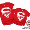 Alt Text: Two red T-shirts with white "Superdad" and "Superkid" designs are displayed. A logo and file format options are visible at the bottom right corner, indicating availability for digital download.
