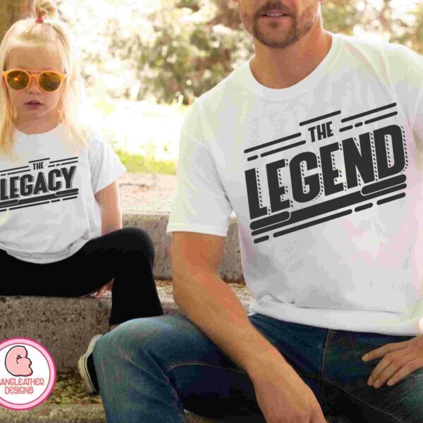 A child wearing a "The Legacy" t-shirt sits next to an adult wearing a "The Legend" t-shirt. They are sitting outside on a stone bench.